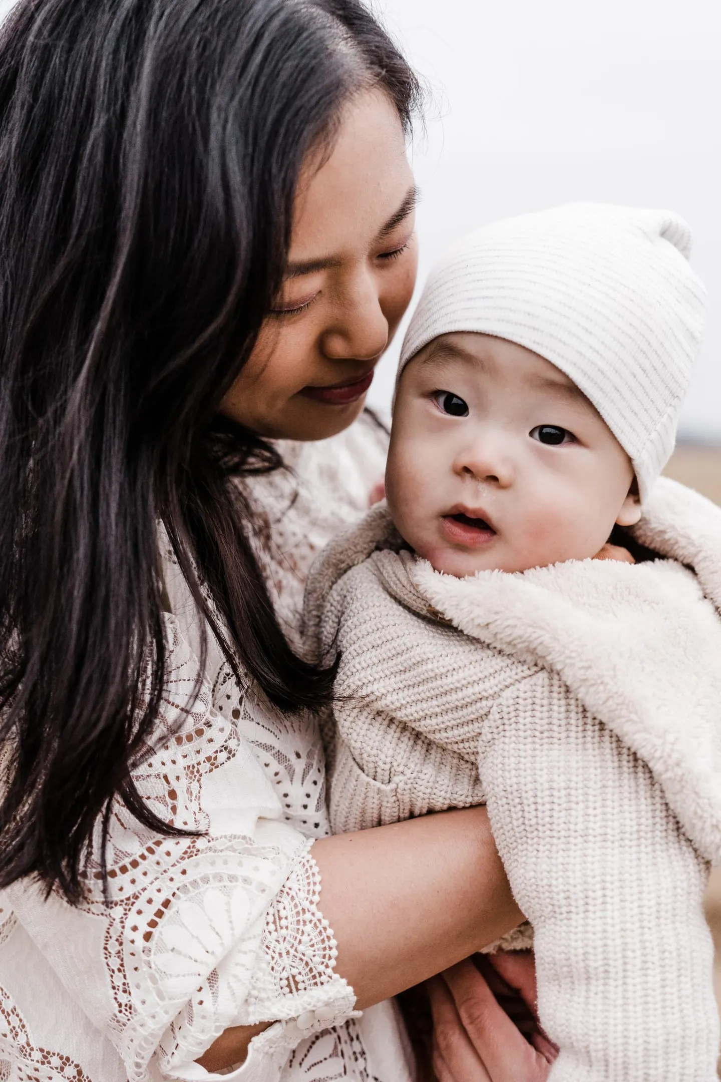 close up pose of mom with 6 month old baby in outdoor family photo session