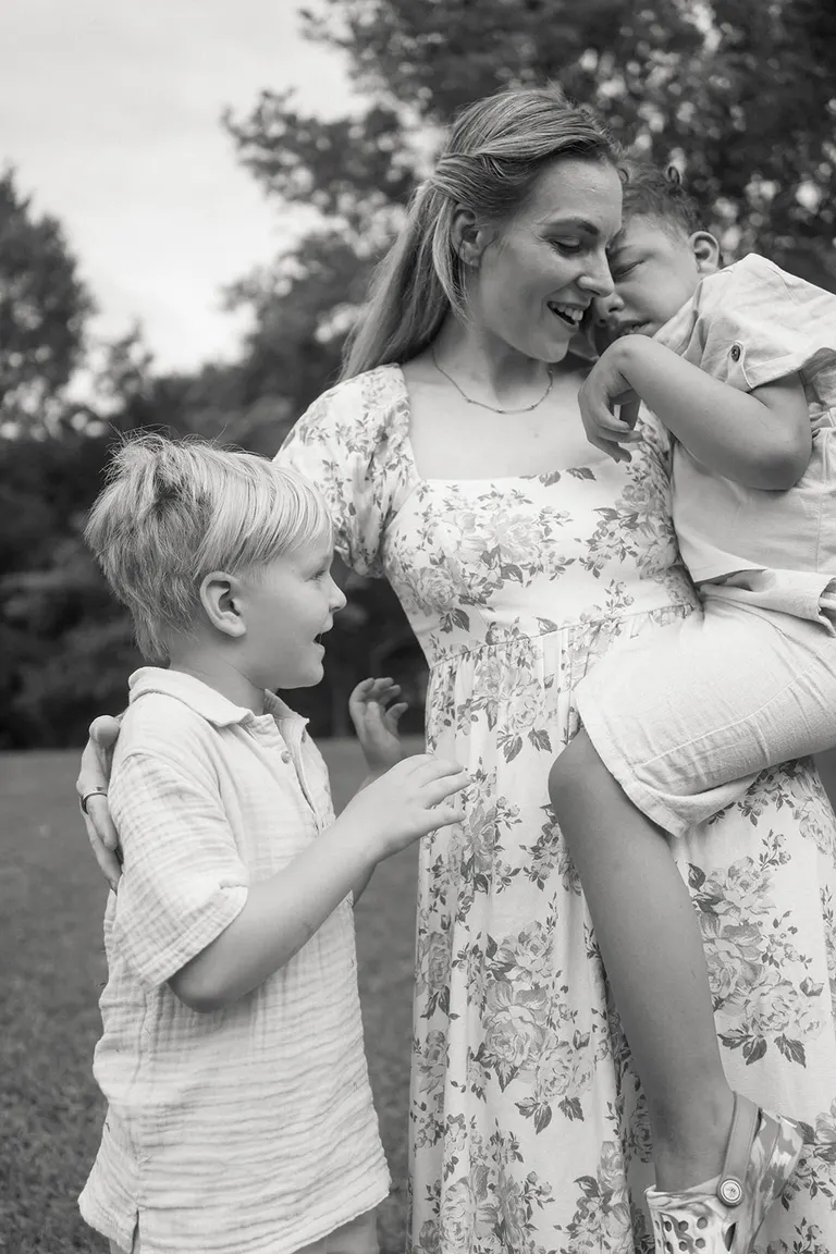 mother holding special needs child in outdoor family photo session