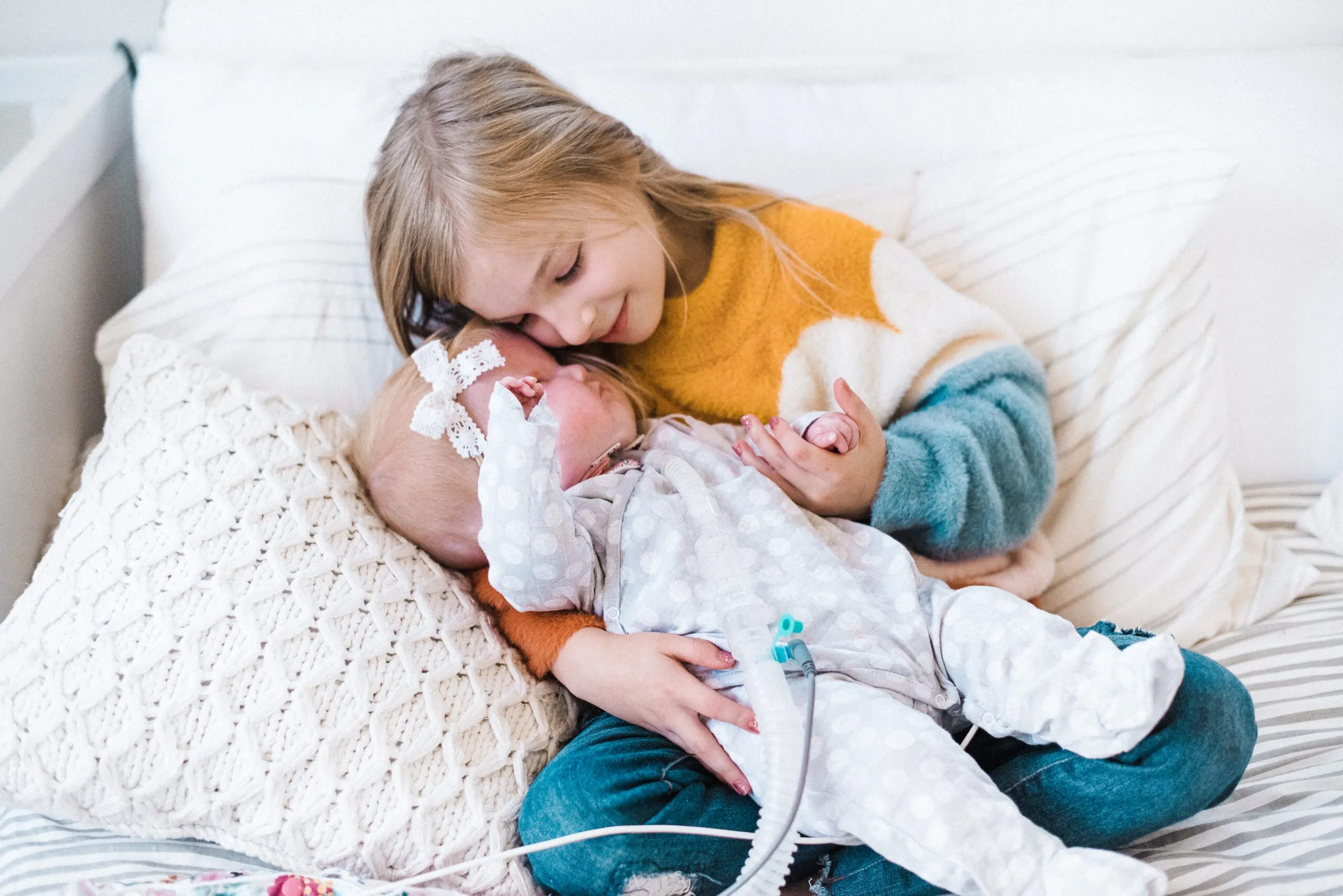 sibling photo, newborn baby with a feeding tube