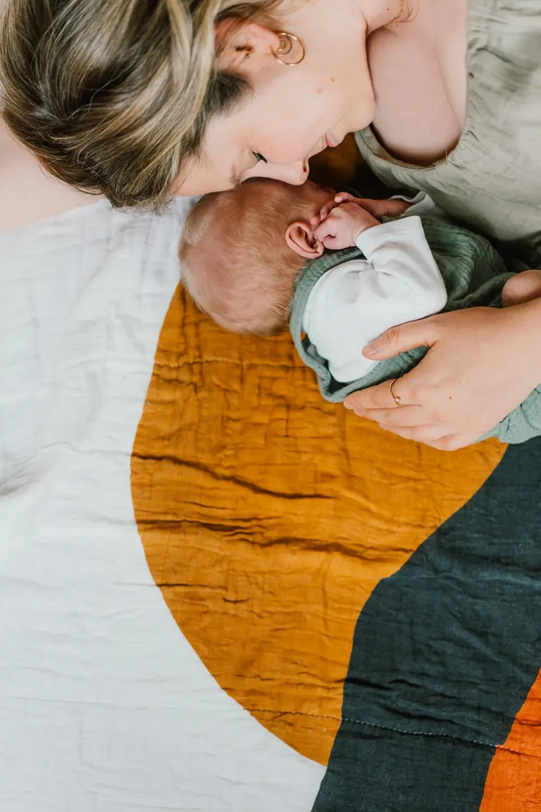 poses with mom and baby in lifestyle newborn session at home