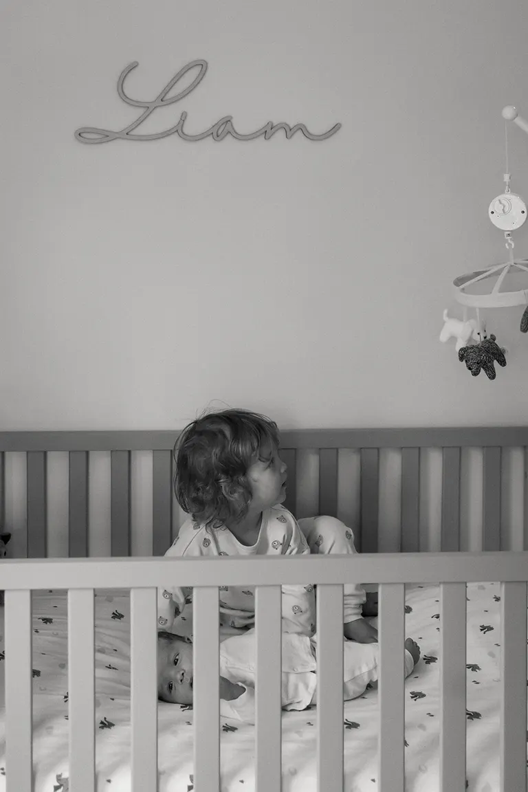 baby and toddler in the same crib, lifestyle newborn photos by Charlottesville photographer
